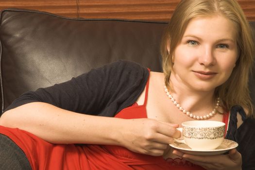 Beautiful young woman enjoying a cup of tea