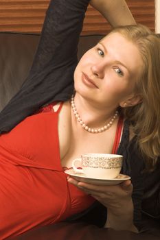 Beautiful young woman enjoying a cup of tea