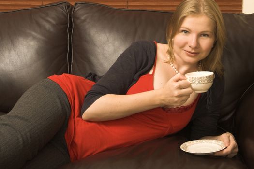 Beautiful young woman enjoying a cup of tea