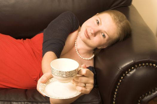 Beautiful young woman enjoying a cup of tea