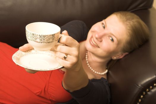 Beautiful young woman enjoying a cup of tea