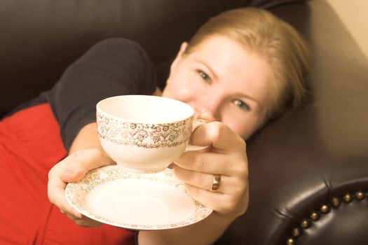 Beautiful young woman enjoying a cup of tea