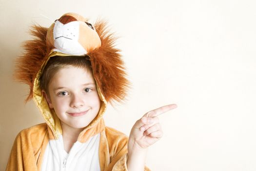 Playful young boy wearing a lion costume