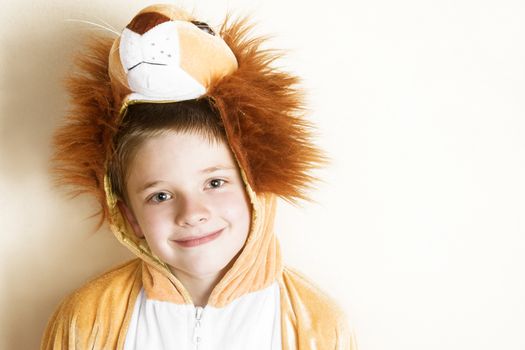 Playful young boy wearing a lion costume