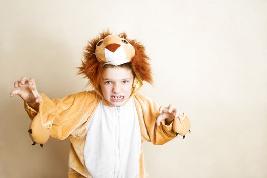 Playful young boy wearing a lion costume