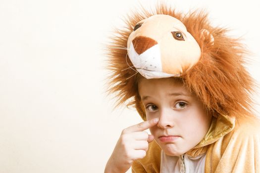Playful young boy wearing a lion costume