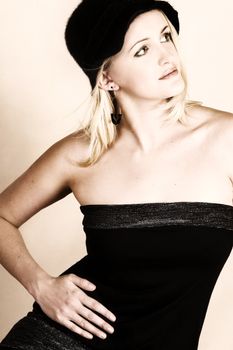 Beautiful young blond model wearing a black hat