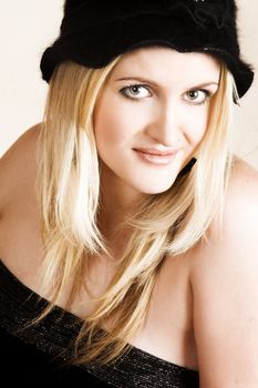 Beautiful young blond model wearing a black hat