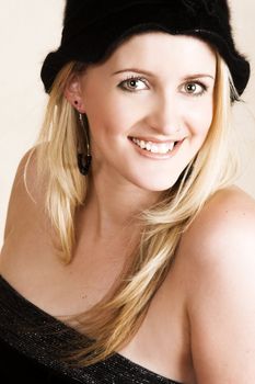 Beautiful young blond model wearing a black hat