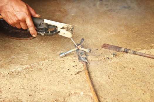 welder man welding steel on cement floor with spread spark