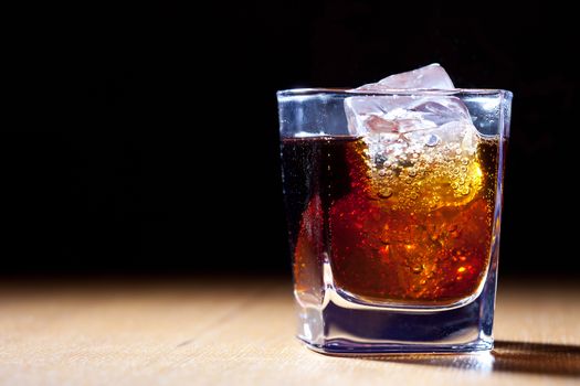 rum and cola in glass with ice