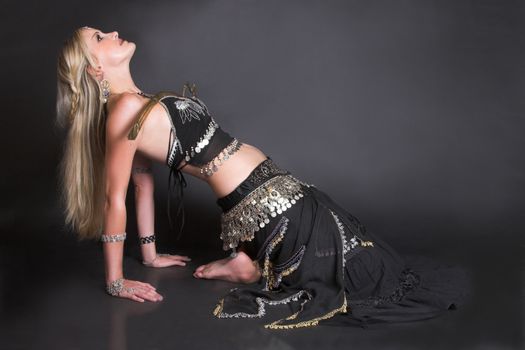 Belly Dancer balancing a tribal sword on her body
