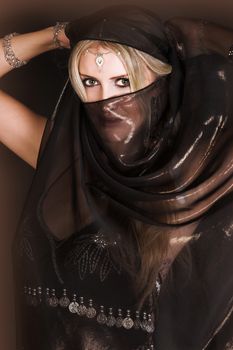 Blond Belly Dancer with long hair holding a scarf