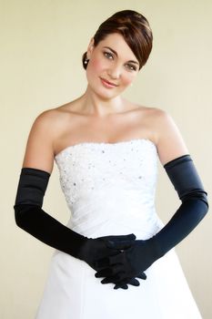 Beautiful Bride in a white dress with fancy gloves