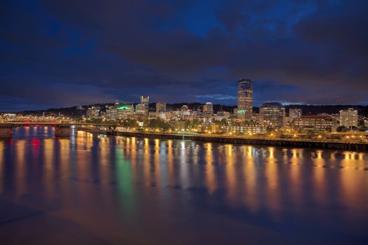 Portland Oregon Downtown City Skyline Along Willamette River Waterfront at Evening Blue Hour with Storm Clouds Panorama
