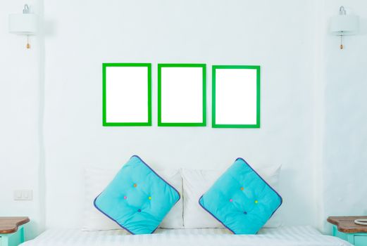 double colorful pillow in the bedroom with photo frame
