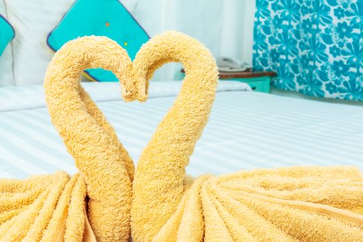 Towel folded in swan heart shape