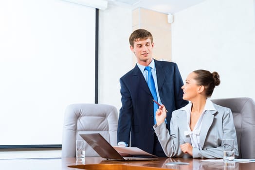 image of a two businessmen discussing documents, teamwork