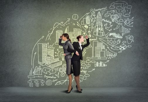 two business women holding hands, looking in different directions, teamwork