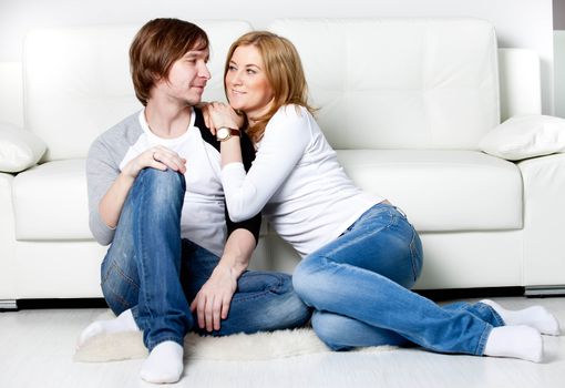 Happy couple relaxing in living room