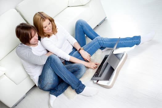 Couple relaxing at home near sofa