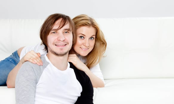 Couple Relaxing On Sofa  In New Home