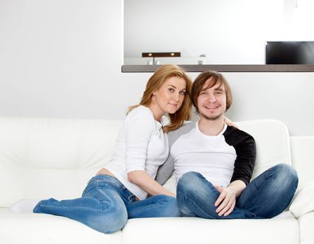 Happy couple relaxing in home