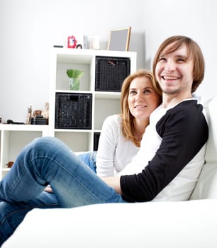 Happy couple relaxing in living room