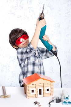 boy with a drill and a new home