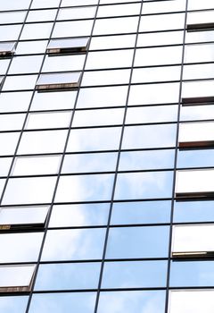 office windows refecting blue sky and cloud