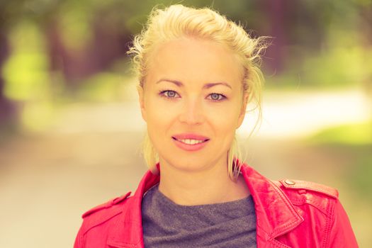 Portrait of happy young woman in the park.