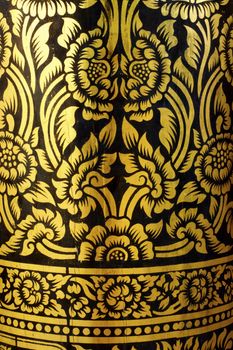 detail of thai pattern that made by covered wood plate with gold leaf for decorated temple door or pillar,shallow focus
