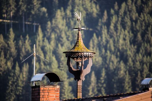 The metal weathercock on the old roof