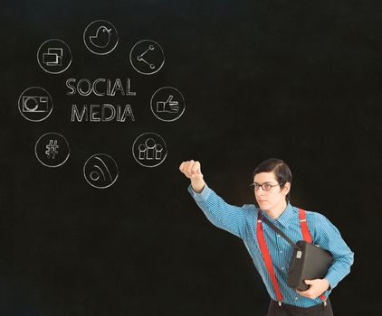 Nerd geek businessman with computer social media network icons on blackboard background
