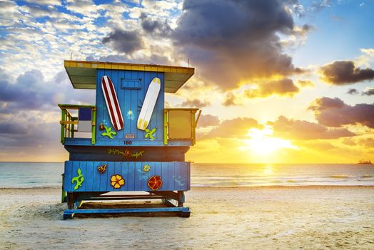 Miami South Beach sunrise with lifeguard tower and coastline with colorful cloud and blue sky. 