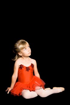 Young ballet dancer wearing a red costume