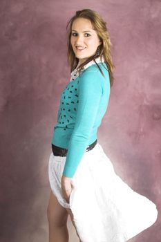 Beautiful young female wearing a white skirt and blue top