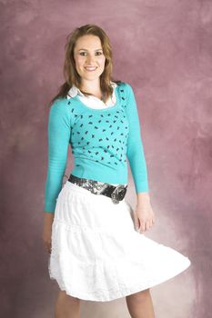 Beautiful young female wearing a white skirt and blue top