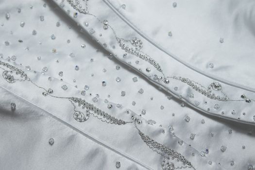 Detail of stiching and beads on a wedding dress