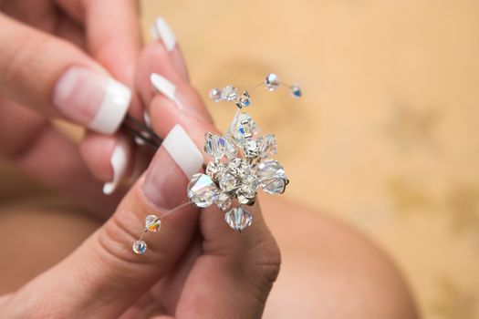 A young bride holding a beautiful hair pin