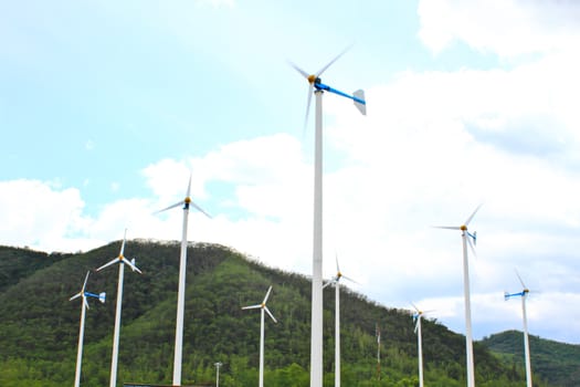 green meadow with Wind turbines generating electricity