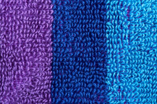 Background of Purple, Navy Blue and Blue Fluffy Cotton Rows closeup