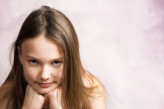 Beautiful young brunette against a pink background
