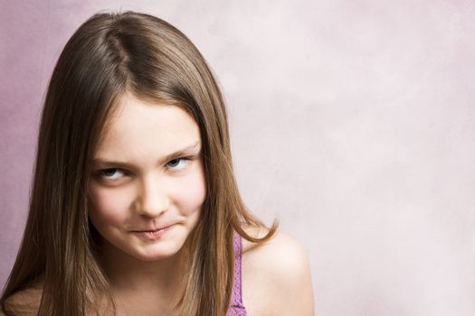 Beautiful young brunette against a pink background
