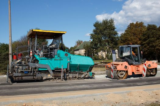 A couple of Asphalt paving machines used in construction