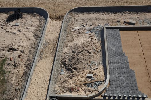 A newly started brick road construction side with smooth stone bricks