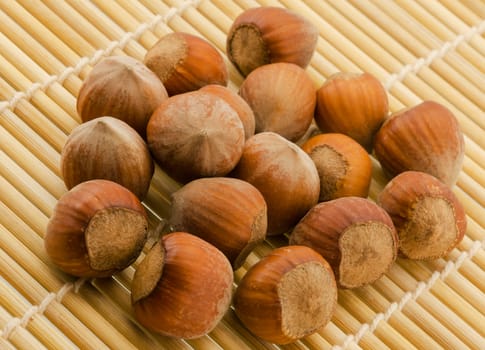 a lot of hazelnuts close-up on a bamboo mat