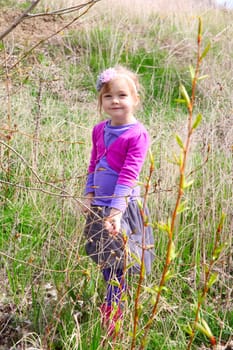 Little girl playing in the field during springtime