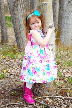 Little girl playing in the field during springtime