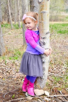 Little girl playing in the field during springtime